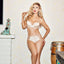Model wearing the Black Heart pink champagne silk lingerie set with gold hardware, styled in a retro-inspired living room with eclectic decor, luxury lingerie campaign image.