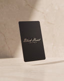 Black Heart Lingerie E-Gift Card presented on warm marble