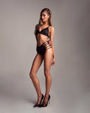 Side view of the Eclipse high waist panty showing the signature strappy side design in black