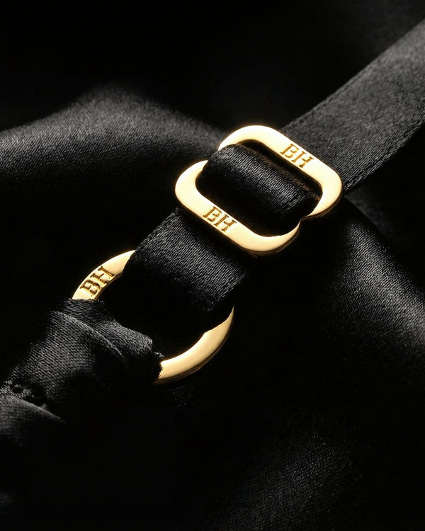 Gold-plated hardware detail on black silk lingerie set