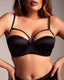 Front view of a woman in a black strappy caged longline bra